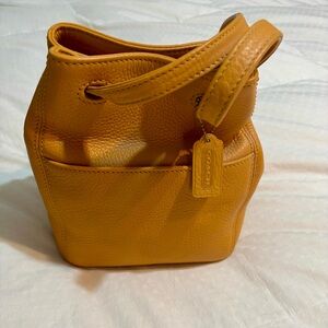 Coach Pebbled Leather Bucket Bag in Mustard Yellow